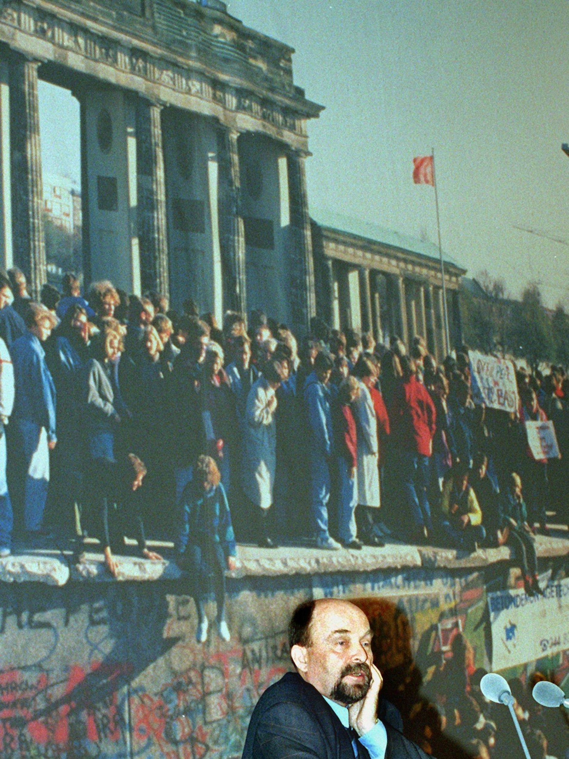 Rainer Eppelmann 1999 vor einem Großfoto des Brandenburger Tores am Morgen nach der Maueröffnung. Vor diesem Foto als Hintergrund sprach Eppelmann bei einer Festveranstaltung zum 10. Jahrestag des Mauerfalls im Roten Rathaus.