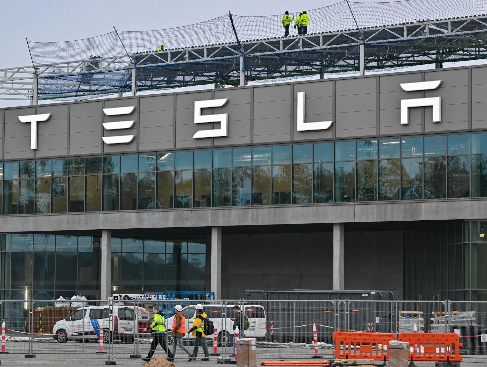 Arbeiter gehen über das Werksgelände der Tesla Gigafactory Berlin-Brandenburg vom US-Elektroautobauer Tesla.