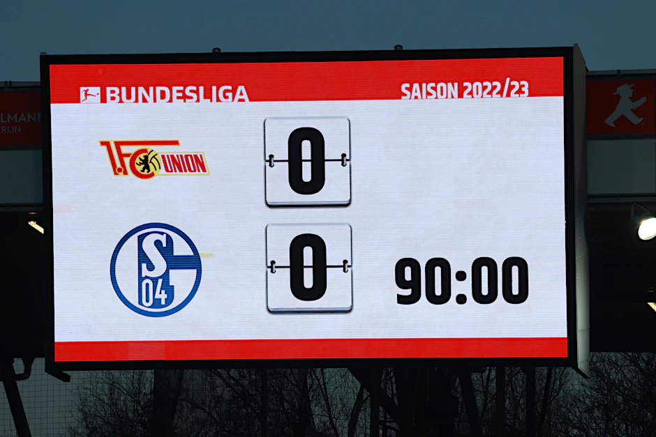 Der 1. FC Union und Schalke 04 schauen von unterschiedlichen Standpunkten auf die Anzeigetafel nach 90 schwer umkämpften Minuten im Stadion An der Alten Försterei.
