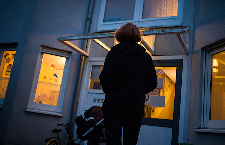 Eine Frau steht vor einem Frauenhaus.