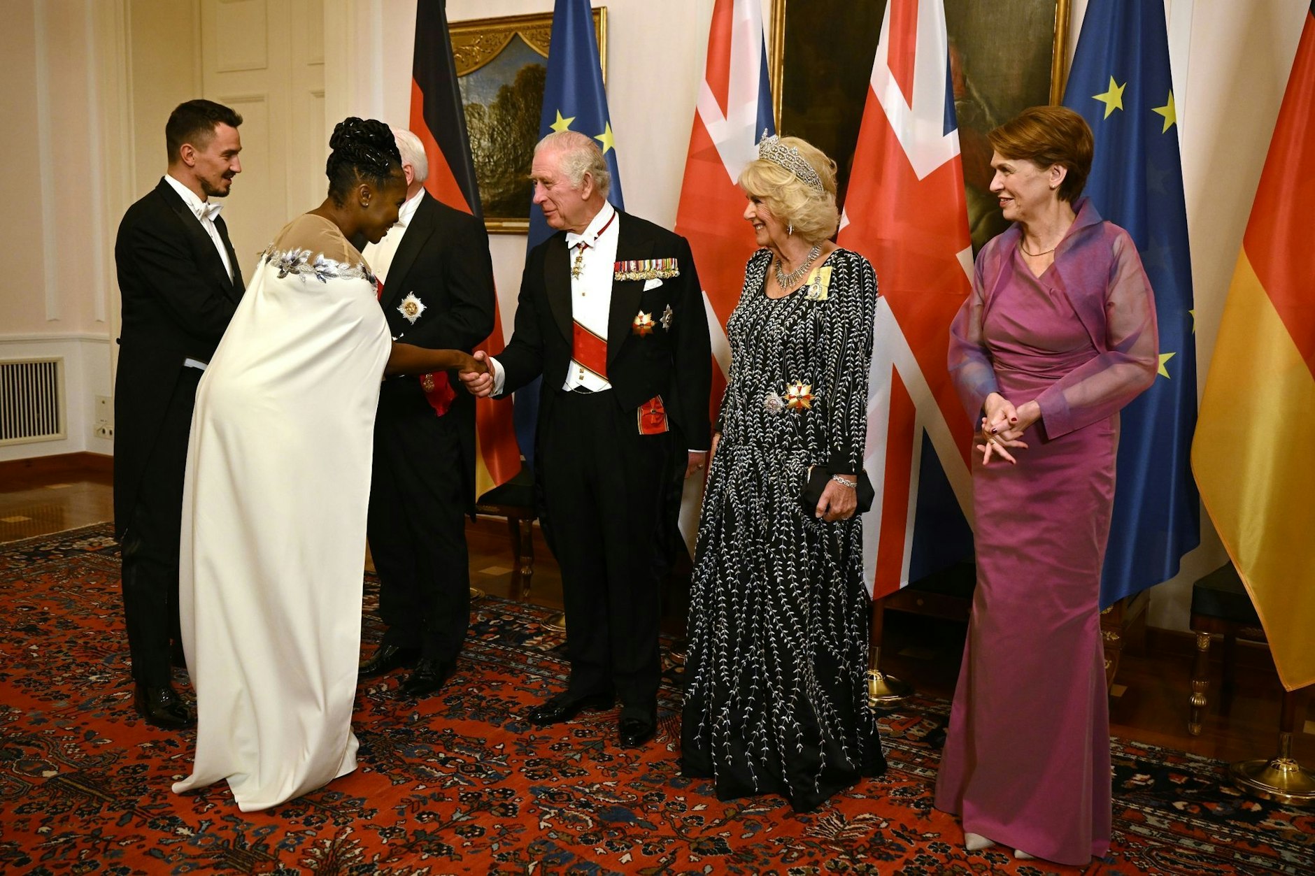 Die Tänzerin Motsi Mabuse (2.v.l.)  schüttelt die Hand von König Charles III. (M). Das Königspaar ist ein großer Fan der TV-Sendung „Let´s Dance“.