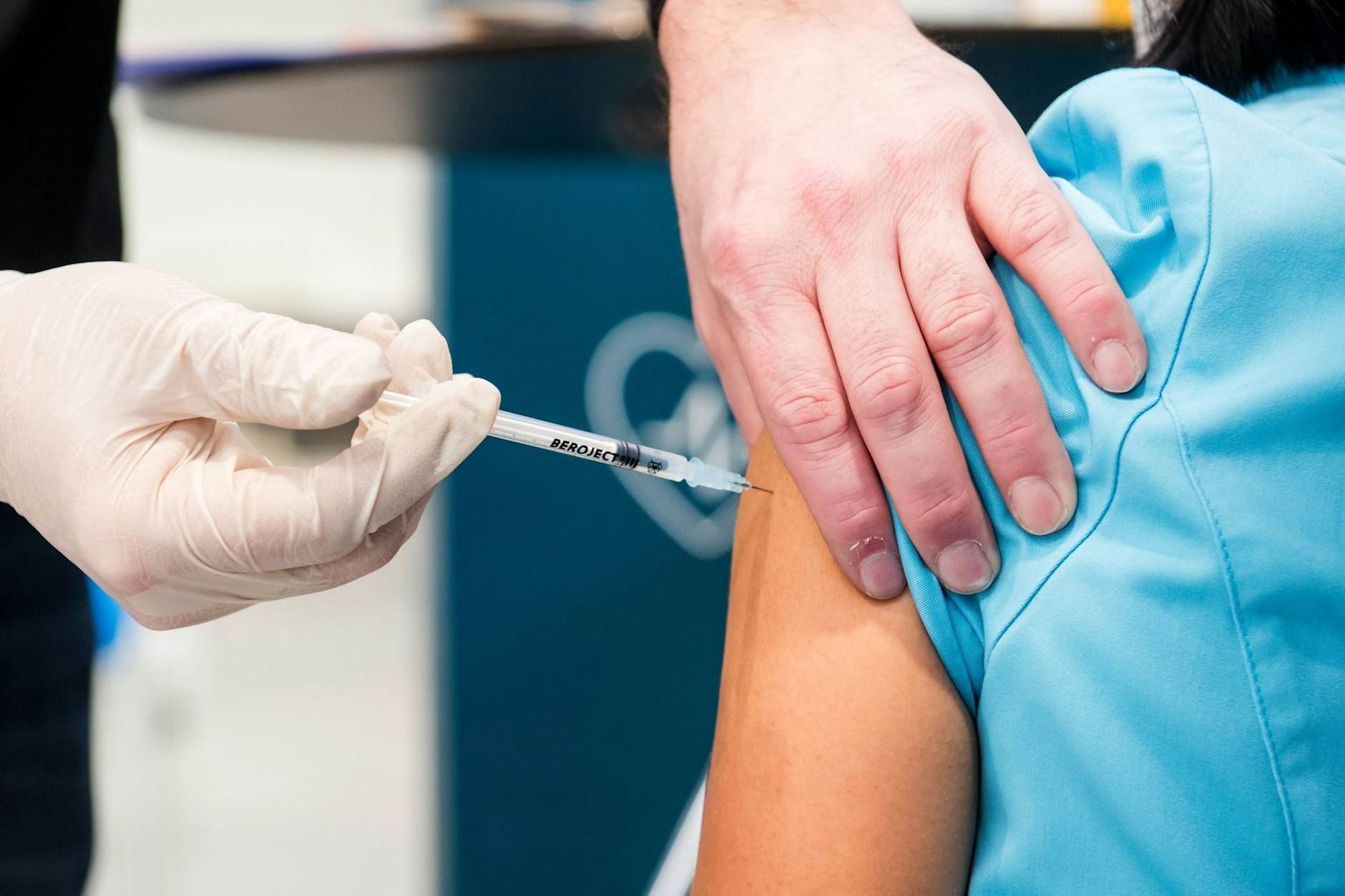 Eine Frau erhält eine Injektion in den Oberarm.