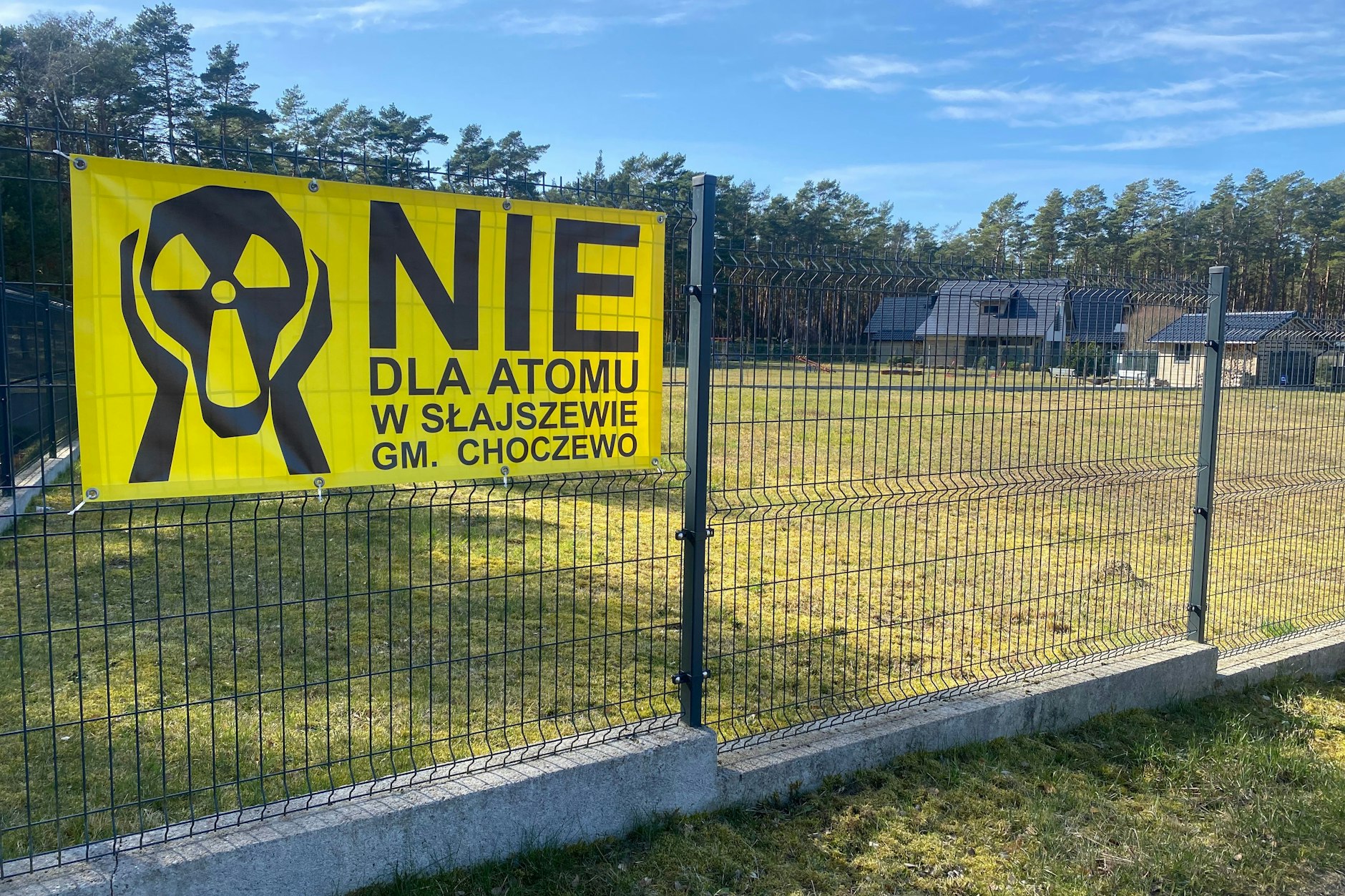 Gegner des geplanten Atomkraftwerks protestieren mit einem Schild in der Nähe vom Strand.