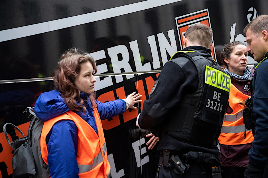 Zwei Klimaaktivisten haben sich an einem Reisebus vor dem Marriott-Hotel am Potsdamer Platz geklebt.