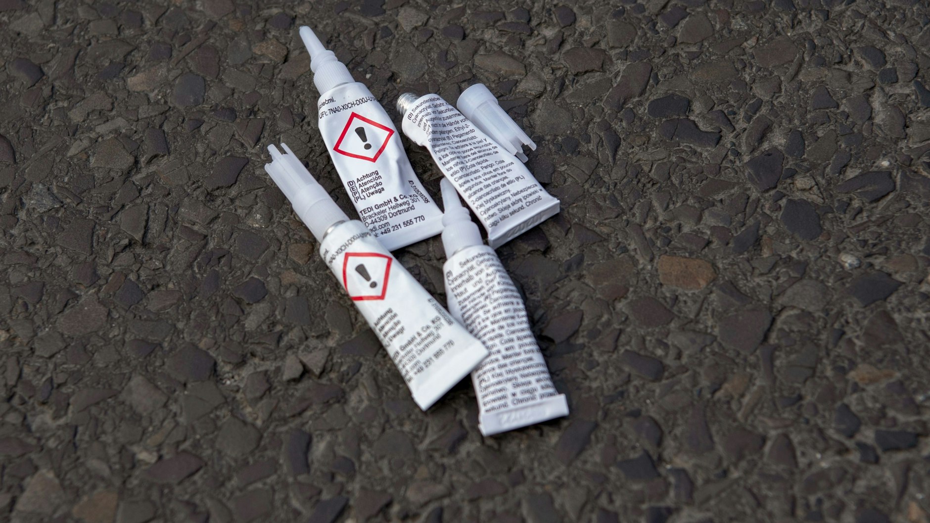 Leere Klebertuben liegen bei einer Blockade von Aktivisten der Gruppierung Letzte Generation auf einer Kreuzung an der Landsberger Allee.