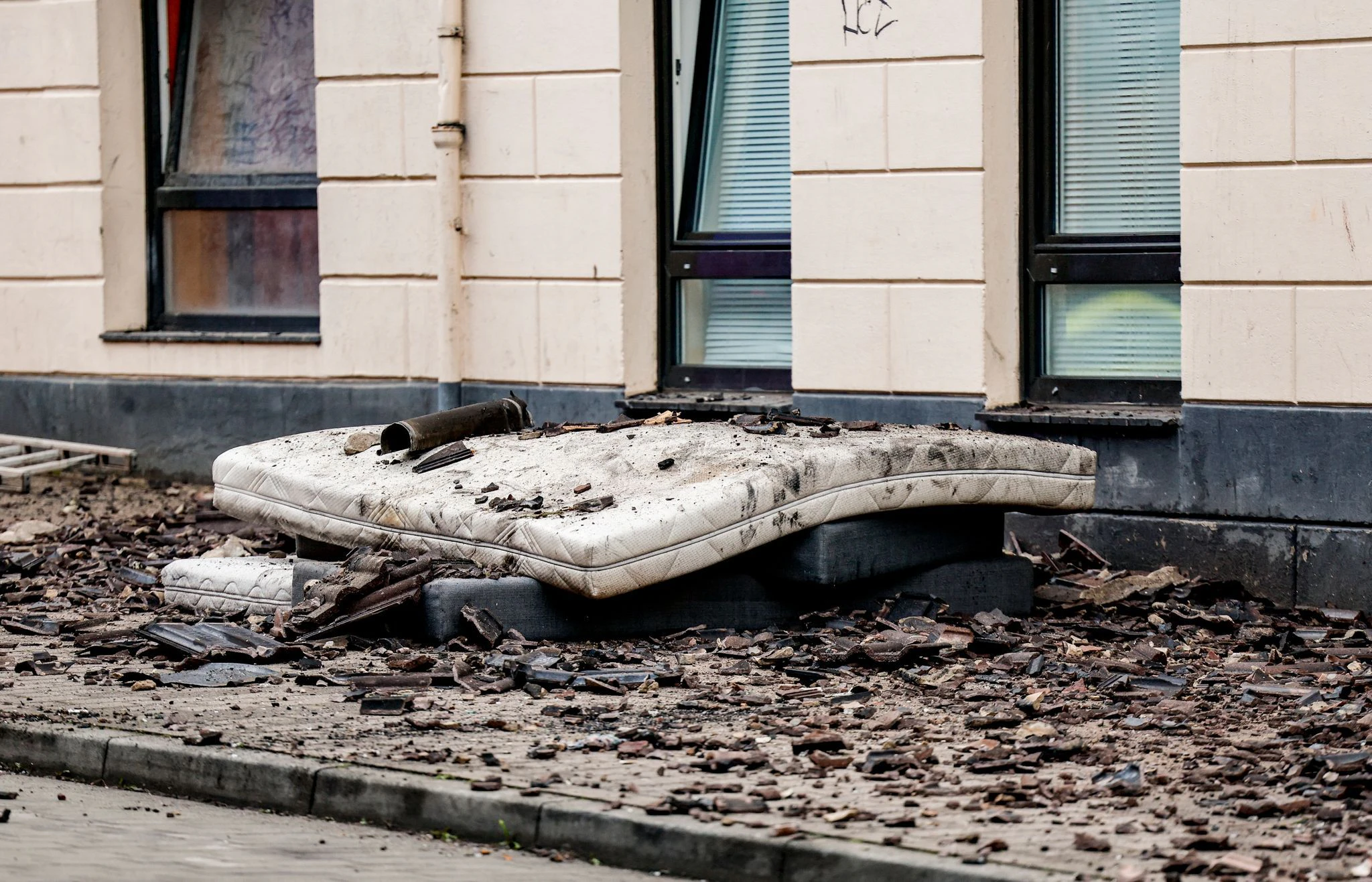 Matratzen, die dazu dienten, Sprünge von Menschen abzufedern, liegen in der Flensburger Neustadt vor einem Haus.  