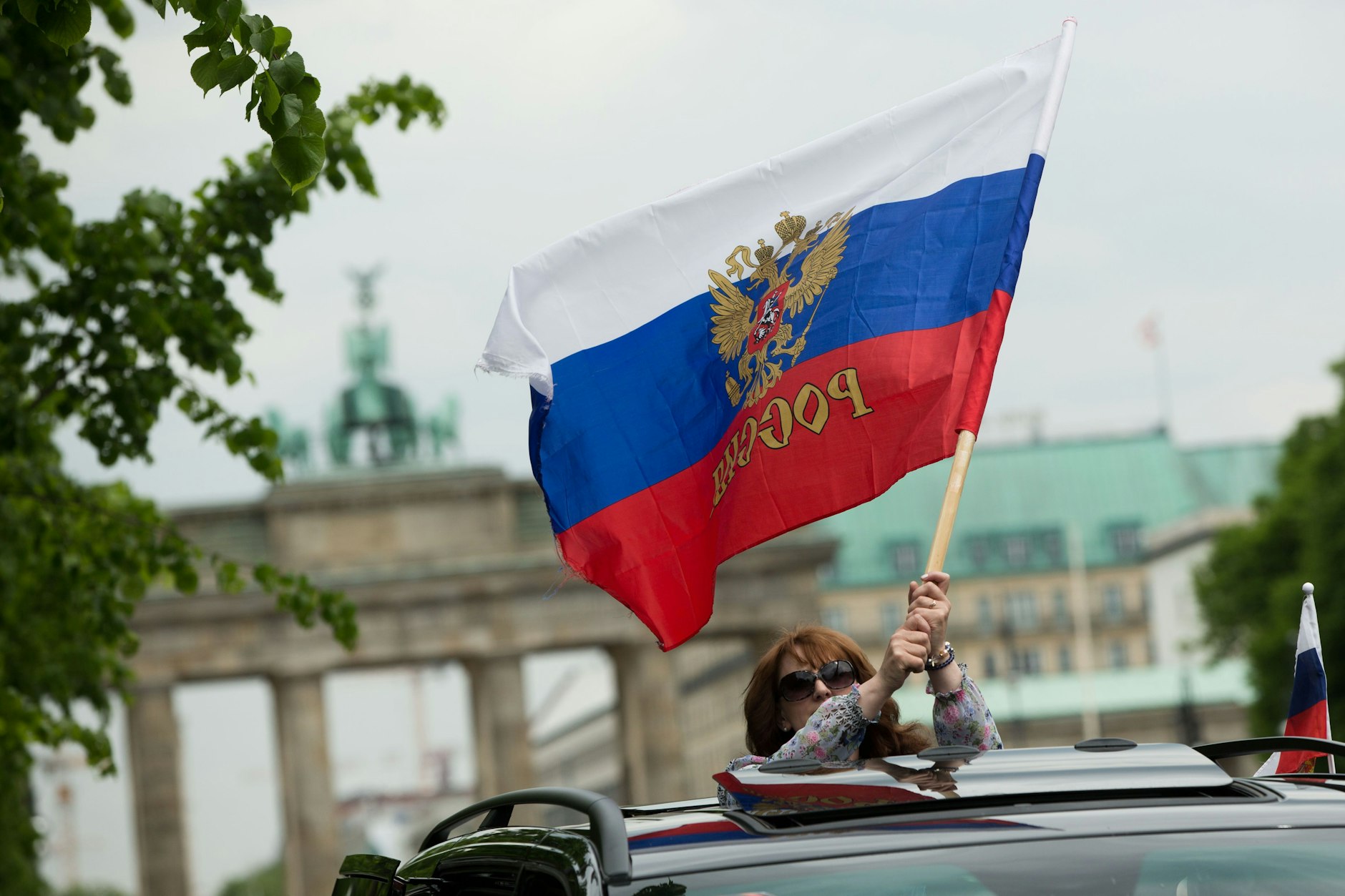 Eine Frau schwenkt anlässlich der Gedenkveranstaltung zum 70. Jahrestag des Kriegsendes am 9. Mai 2015 auf der Straße des 17. Juni die Russlandfahne.