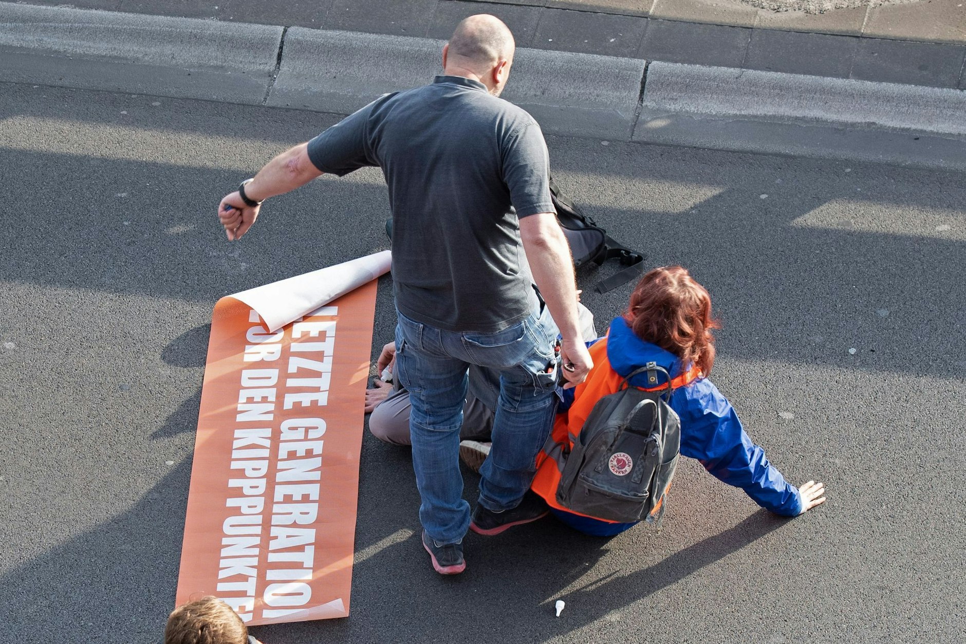 Bei einer Blockade der Gruppe Letzte Generation tritt ein Mann gegen einen Aktivisten.