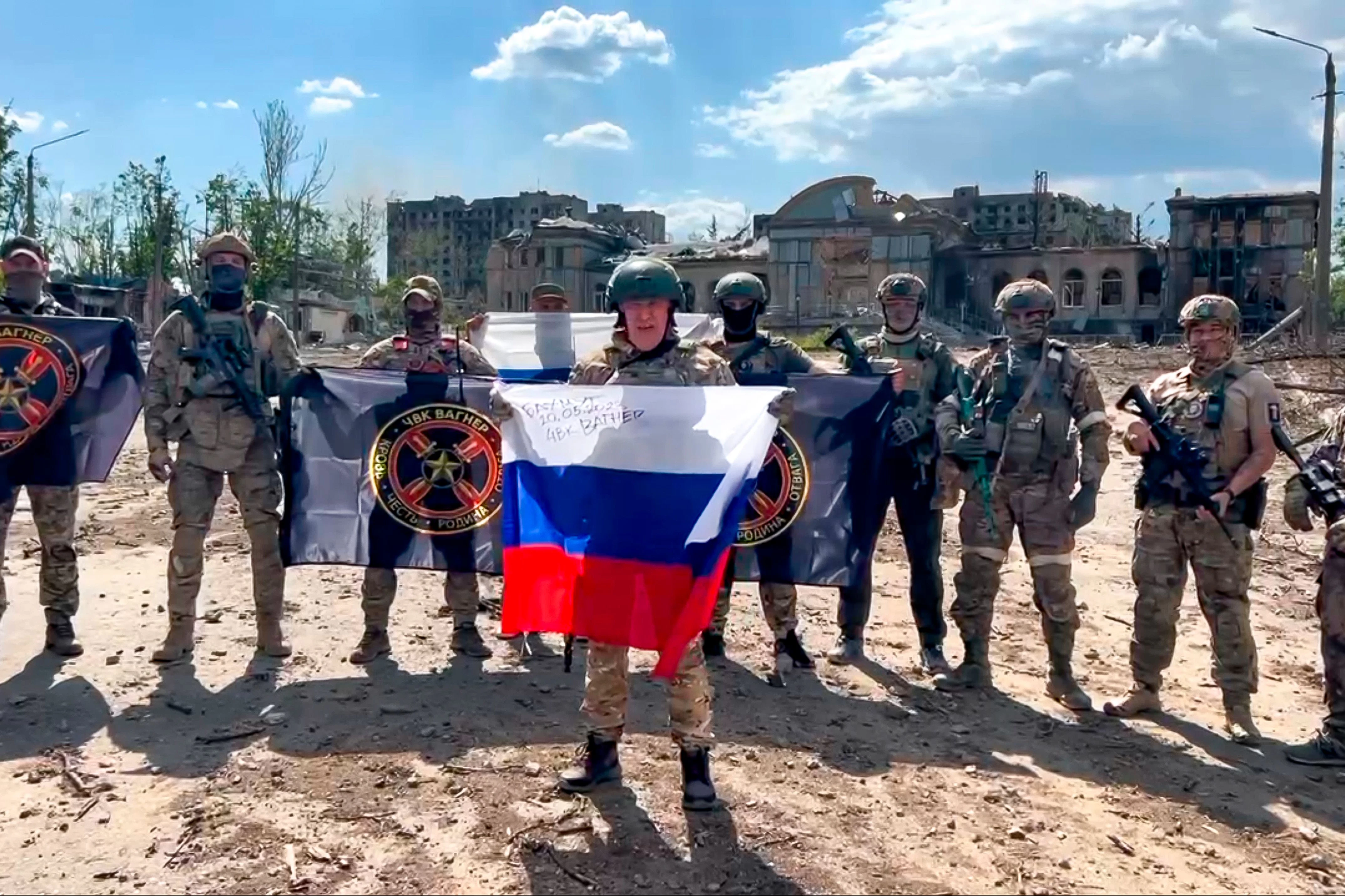 Auf diesem vom Prigoschin-Pressedienst veröffentlichten Foto spricht Jewgeni Prigoschin (M.), der Chef des Militärunternehmens Wagner Group, mit einer russischen Nationalfahne in der Hand vor seinen Soldaten.