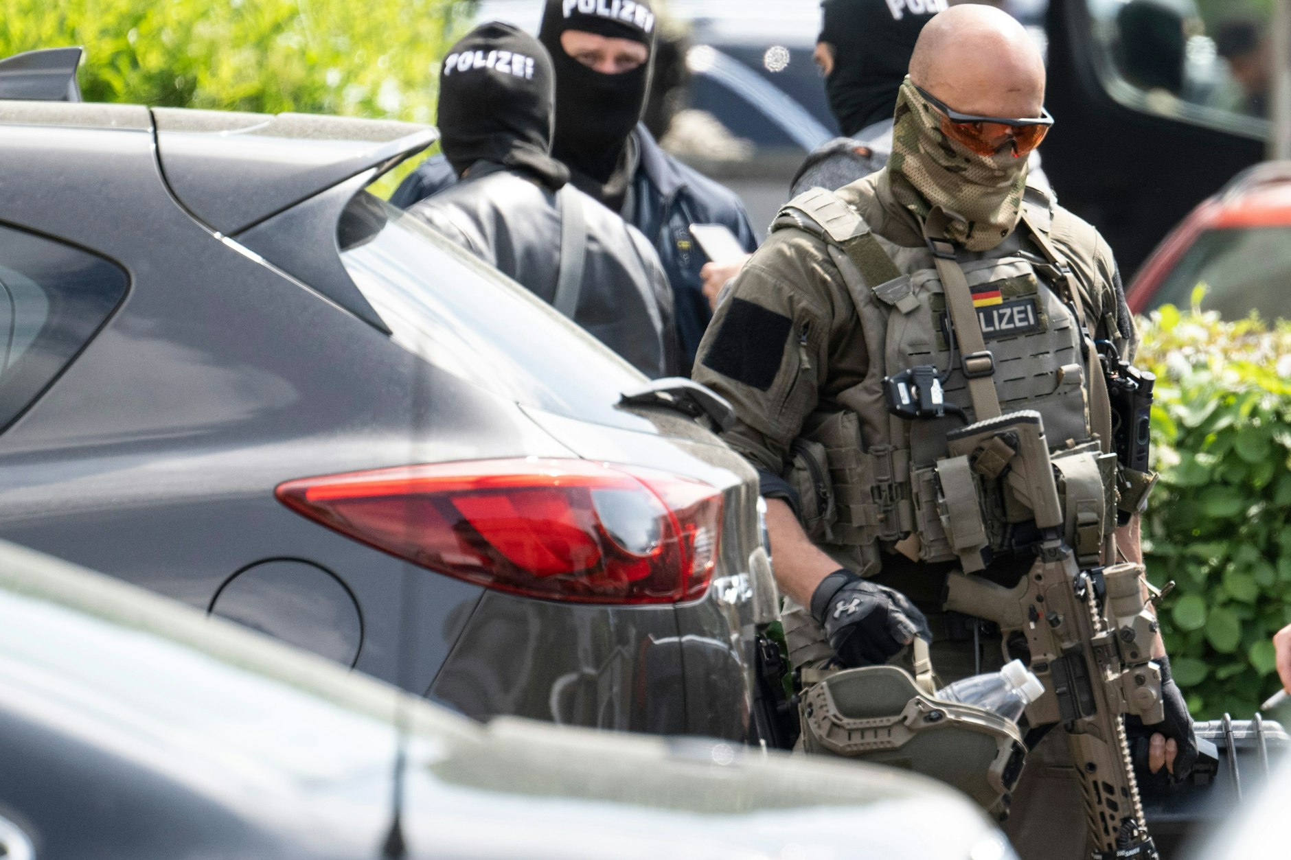 Beamte eines SEK der Polizei verlassen den Einsatzort in einem Wohngebiet in Nierstein.