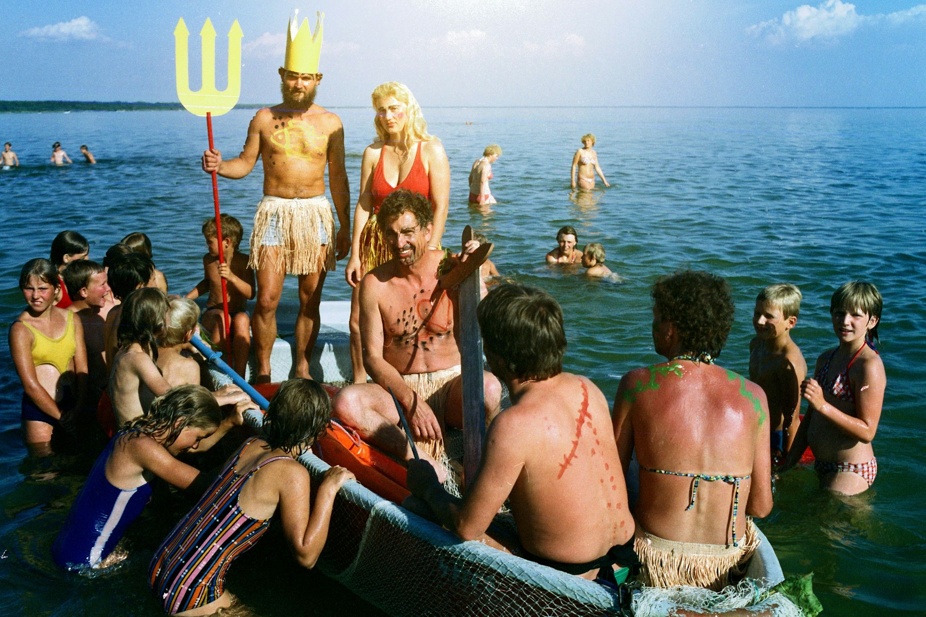 Traditionelles Neptunfest an der Müritz, Juli 1986: Kinder des FDGB-Ferienheims Klink begrüßen freudig im Wasser den in einem Boot ankommenden Neptun und sein Gefolge.