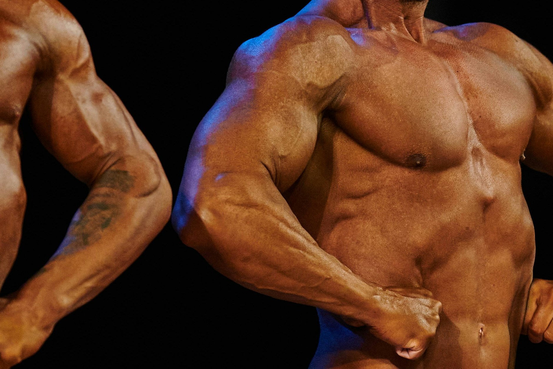 Bodybuilder treten bei einem Wettbewerb auf.