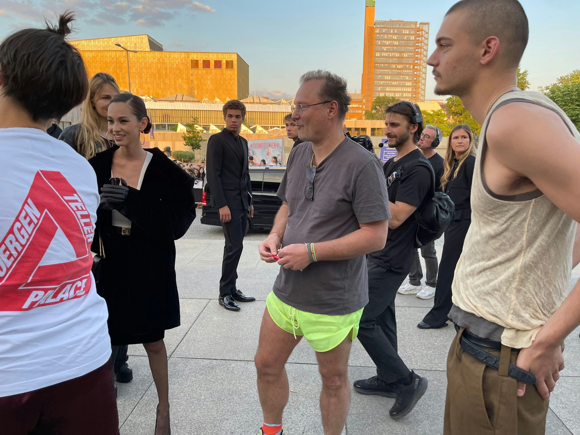 Conformity does not come naturally to the artist Juergen Teller.  He appears at the Saint Laurent show in a T-shirt, shorts and sneakers, as if he had just come from a jog.  Pictured right, his son.