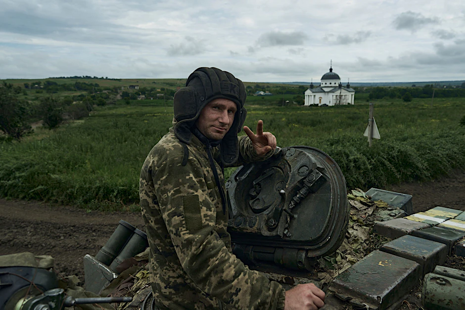 Ein ukrainischer Soldat zeigt ein Siegeszeichen auf einem Panzer an der Frontlinie bei Bachmut.
