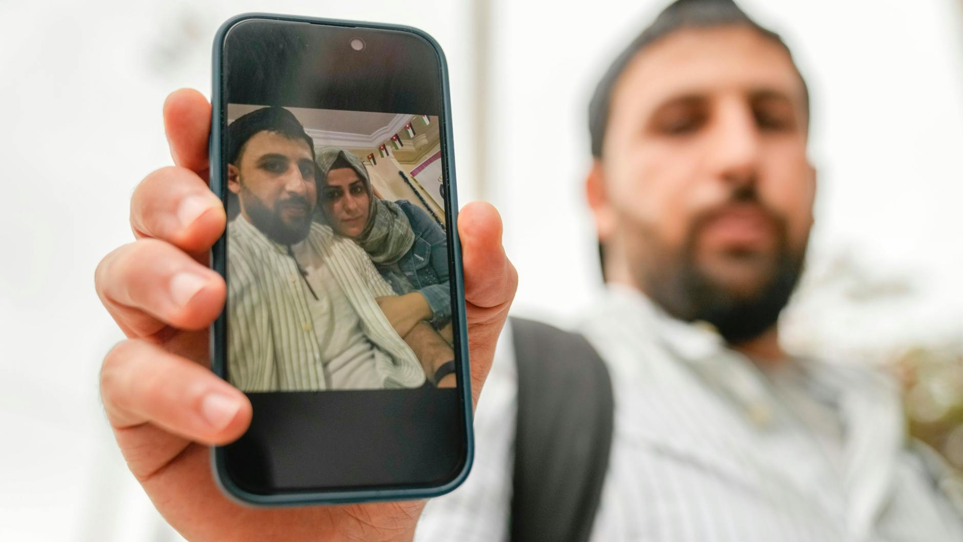 Kassem aus Hamburg zeigt ein Selfie mit seiner Frau Ezra auf dem Handy. Sie und ihr Bruder waren sehr wahrscheinlich auf dem Todesschiff und werden vermisst. (AP Photo/Thanassis Stavrakis)