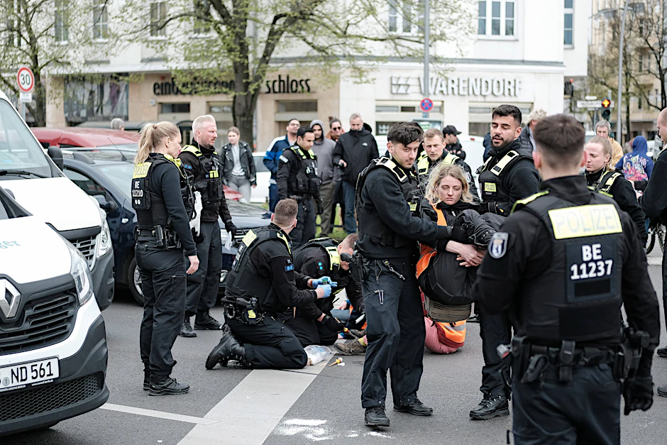 Die Auseinandersetzung fand wohl bei einem Protest der Klimakleber an der Otto-Suhr-Allee statt. Hier ist ein Protest der Letzten Generation dort im April zu sehen, bei dem die Aktivisten von der Polizei entfernt wurden.