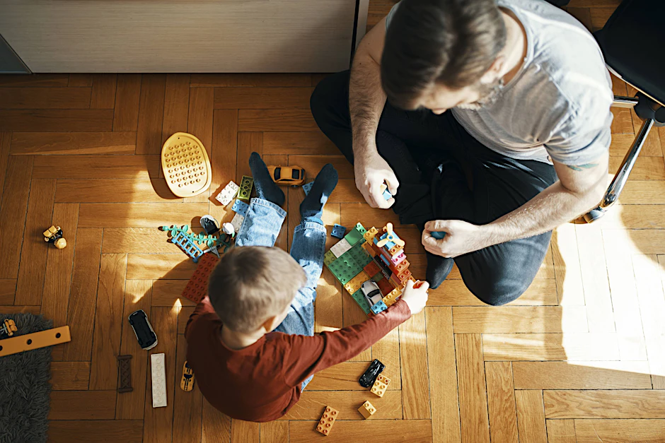 Vater und Sohn spielen zusammen mit Lego-Bausteinen