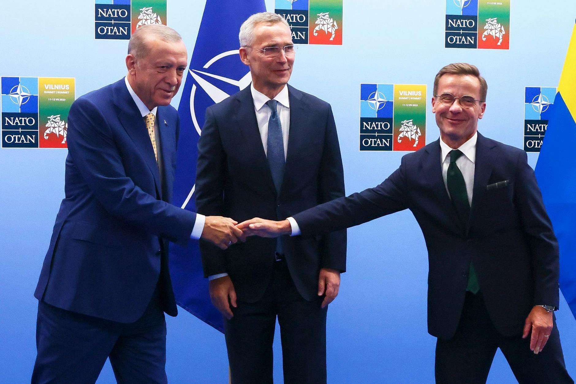 Der türkische Präsident Recep Tayyip Erdogan (l.) und der schwedische Regierungschef Ulf Kristersson (r.) reichen sich im Beisein von Nato-Generalsekretär Jens Stoltenberg die Hände.