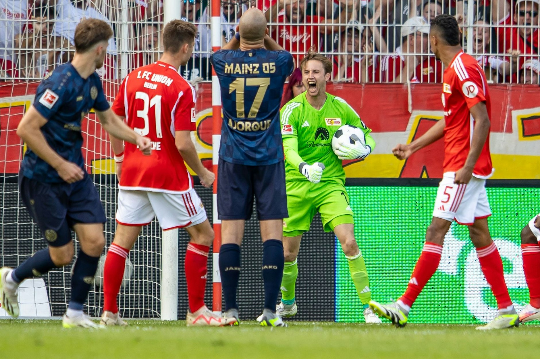 Elfer gehalten! Frederik Rönnow lässt seine ganzen Emotionen raus. Der Mainzer Schütze Ajorque schlägt derweil die Hände vor den Kopf.