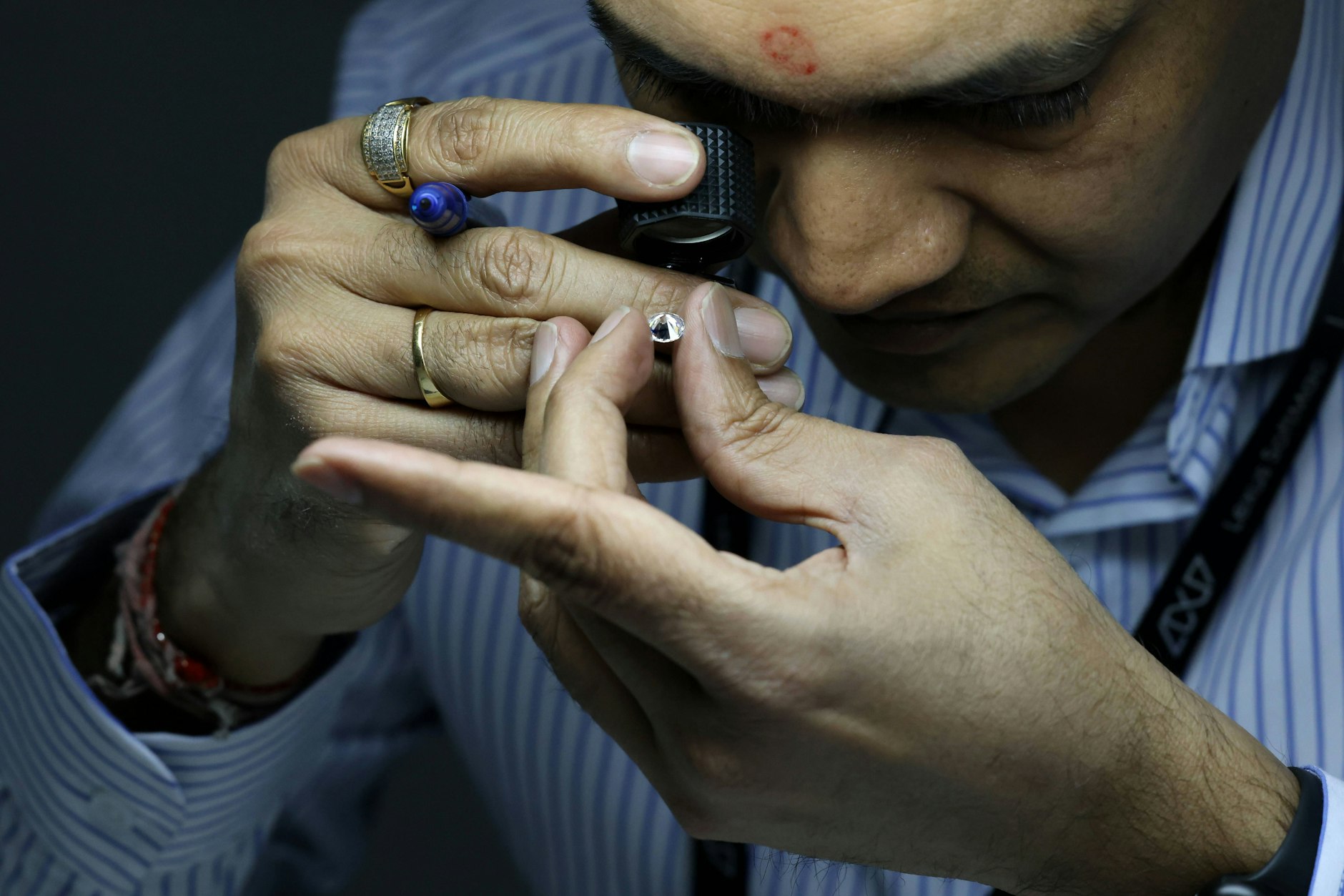 Ein indischer Mitarbeiter überprüft die Qualität von geschliffenen Diamanten in Wladivostok, Russland.