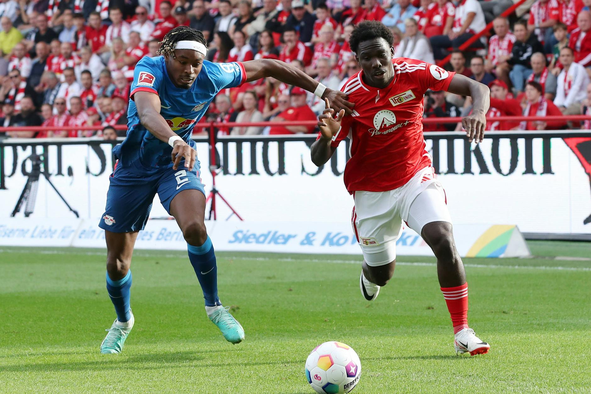 David Datro Fofana (r.) vom 1. FC Union hat im Laufduell mit Leipzigs Mohamed Simakan die Fußspitze vorn.