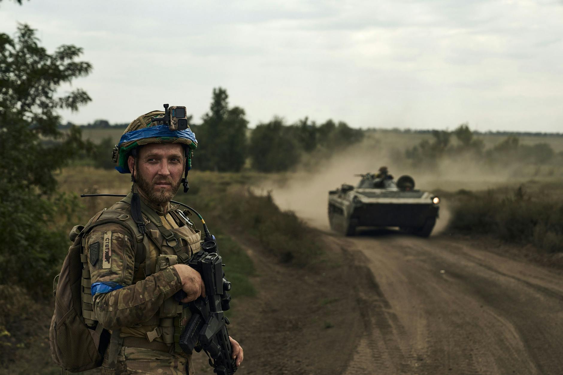 A soldier of Ukraine's 3rd Separatist Brigade looks at an armored personnel carrier near Bakhmut, the scene of fierce fighting with Russian forces in the Donetsk region, Ukraine