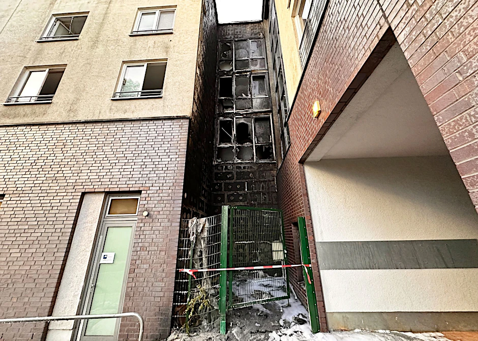 Blick auf die rußgeschwärzte Fassade eines Gebäudes im Berliner Bezirk Marzahn-Hellersdorf.  