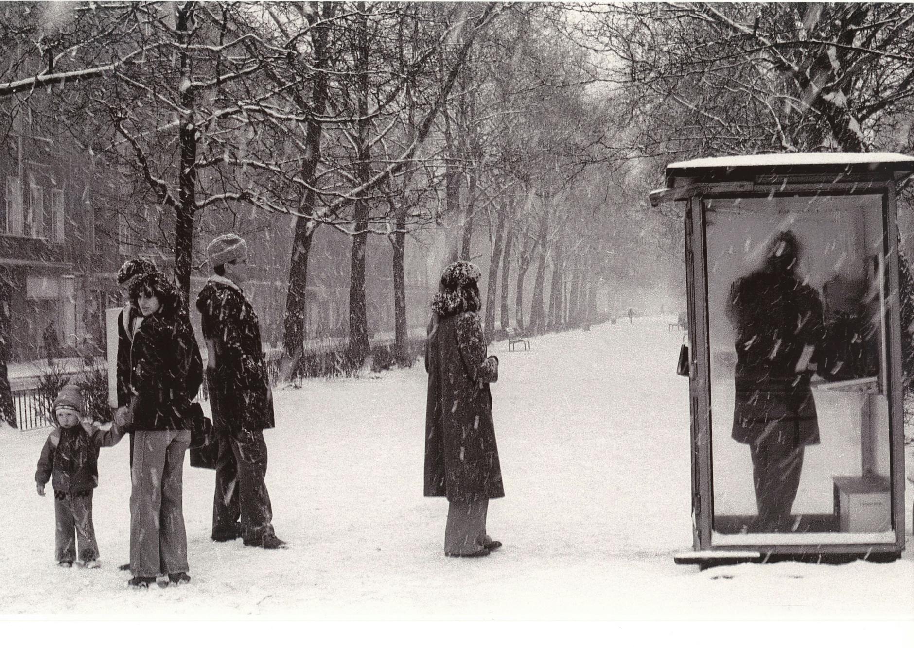 „Fasse Dich kurz“. Im Winter 1985/86 stehen Menschen auf dem Mittelstreifen der Warschauer Straße Schlange vor einem Telefonhäuschen.