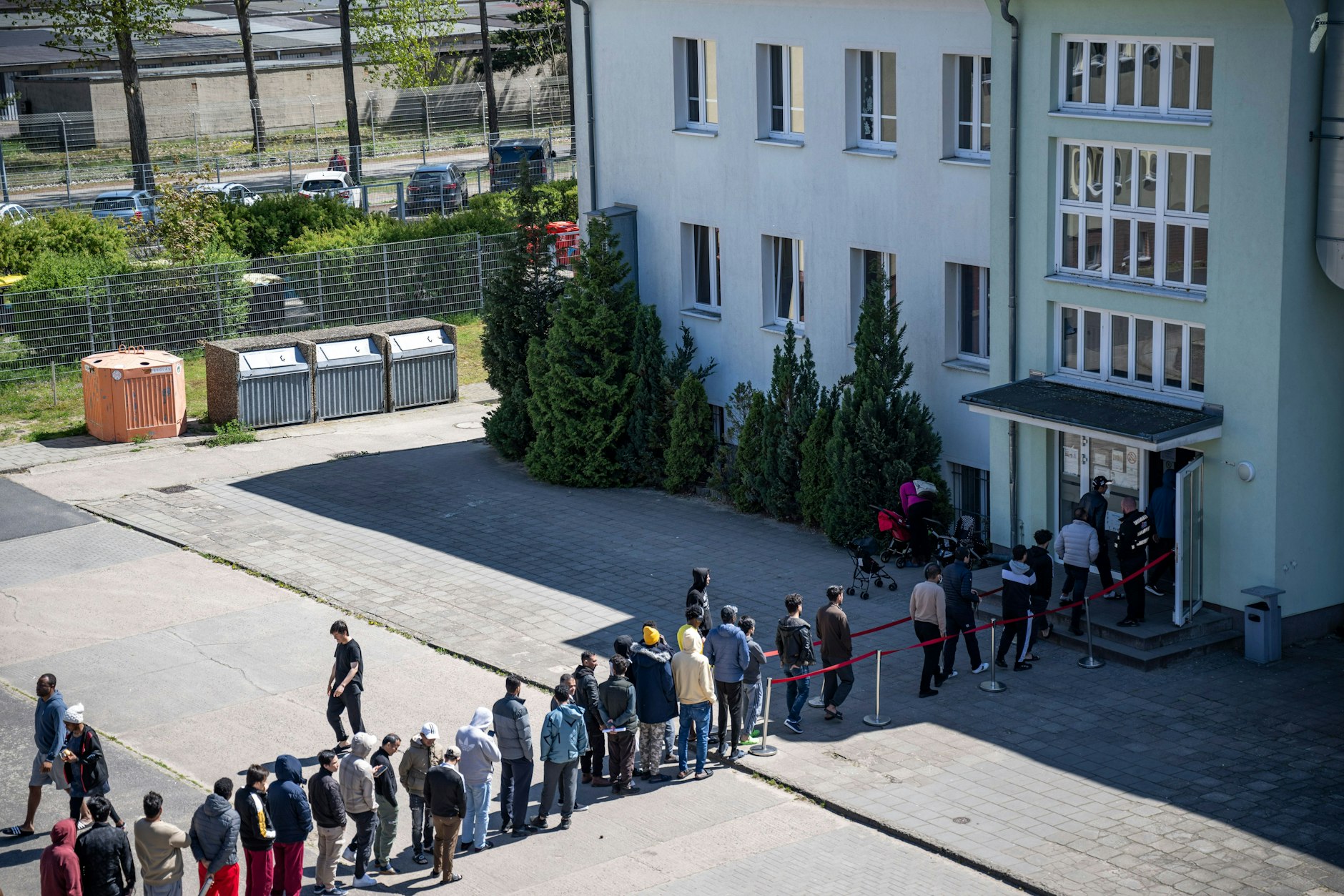 Migranten stehen in einer Schlange der Erstaufnahmeeinrichtung (EAE) des Landes Brandenburg in Eisenhüttenstadt.