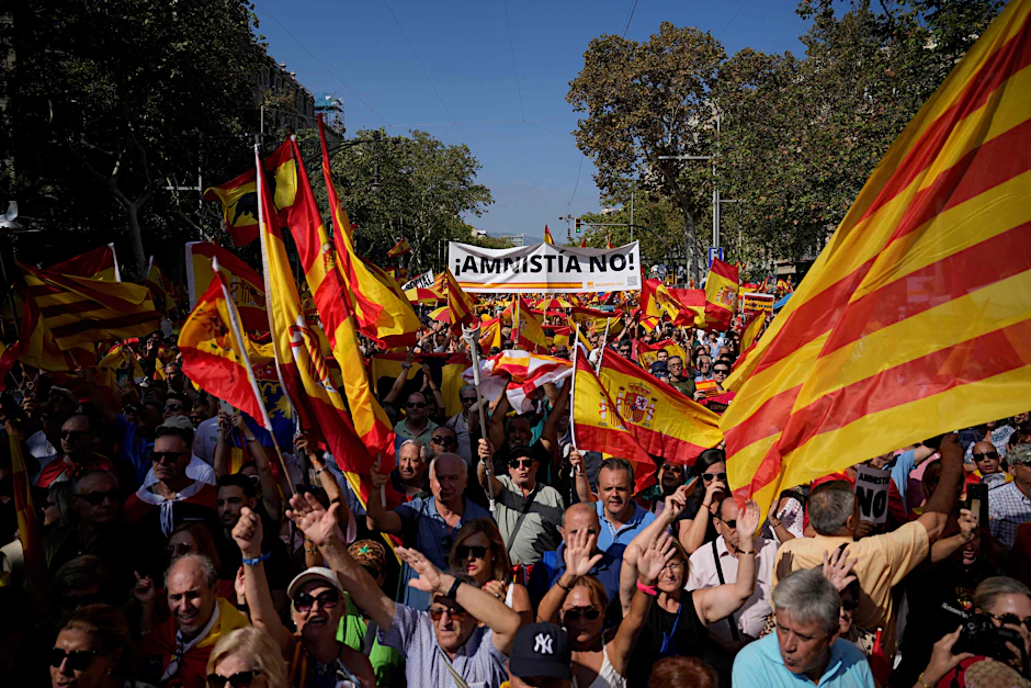 Die Demonstranten im Stadtzentrum von Barcelona schwenken spanische und katalanische Flaggen und halten&nbsp; Schilder mit der Aufschrift „Keine Amnestie“.&nbsp;