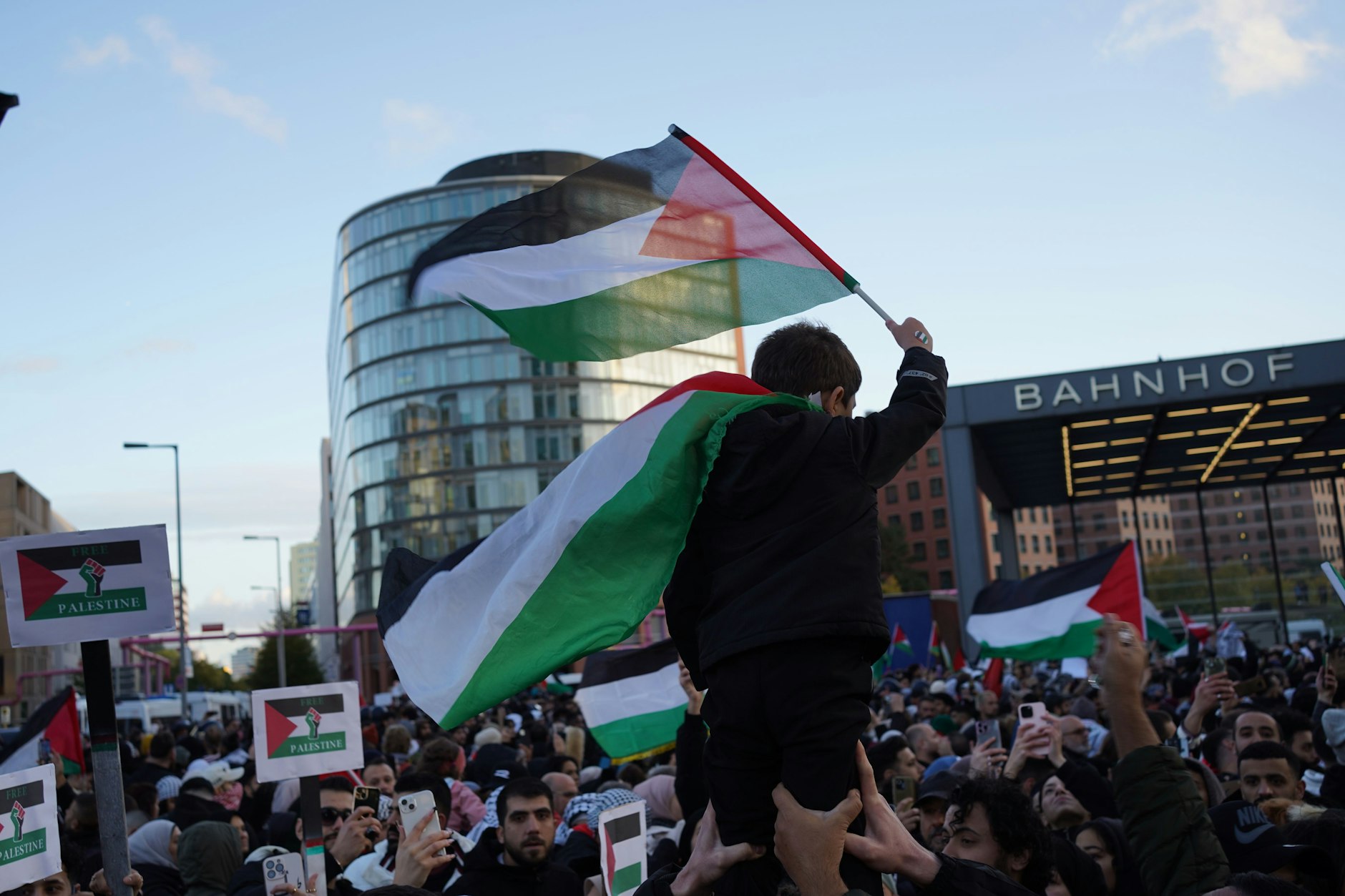 Ein kleiner Junge auf dem Potsdamer Platz demonstriert für Palästina.