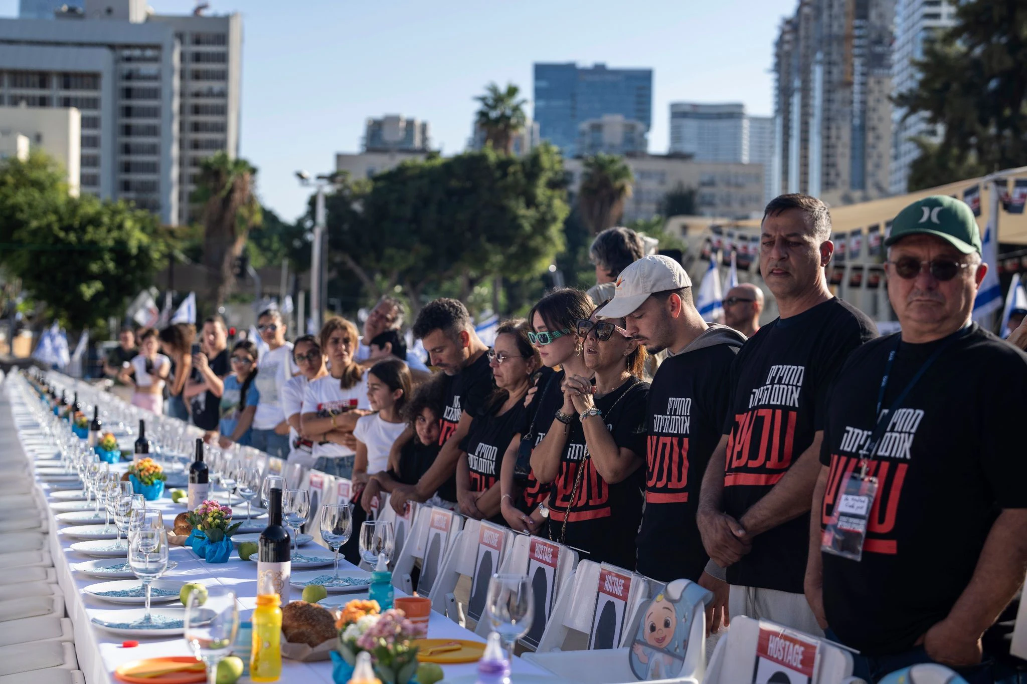 Angehörige von Menschen, die von Hamas-Kämpfern entführt wurden, beten in Tel Aviv umgeben von 203 leeren Stühlen.  