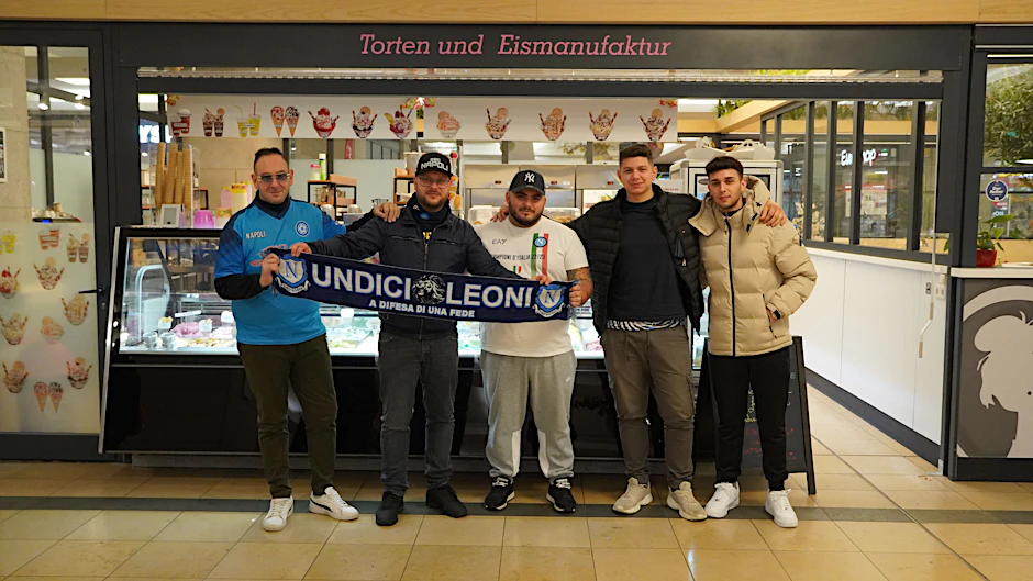 Fünf Anhänger der SSC Neapel bereiten sich vor einem italienischen Café am Alexanderplatz auf das Champions-League-Spiel gegen den 1. FC Union Berlin vor.