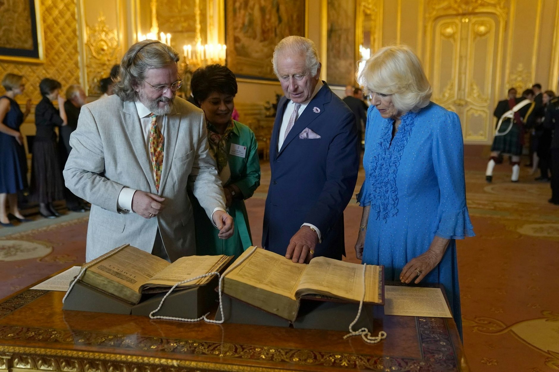 ARCHIV - König Charles III. und Königin Camilla betrachten das erste Shakespeare-Folio während eines Empfangs auf Schloss Windsor.  