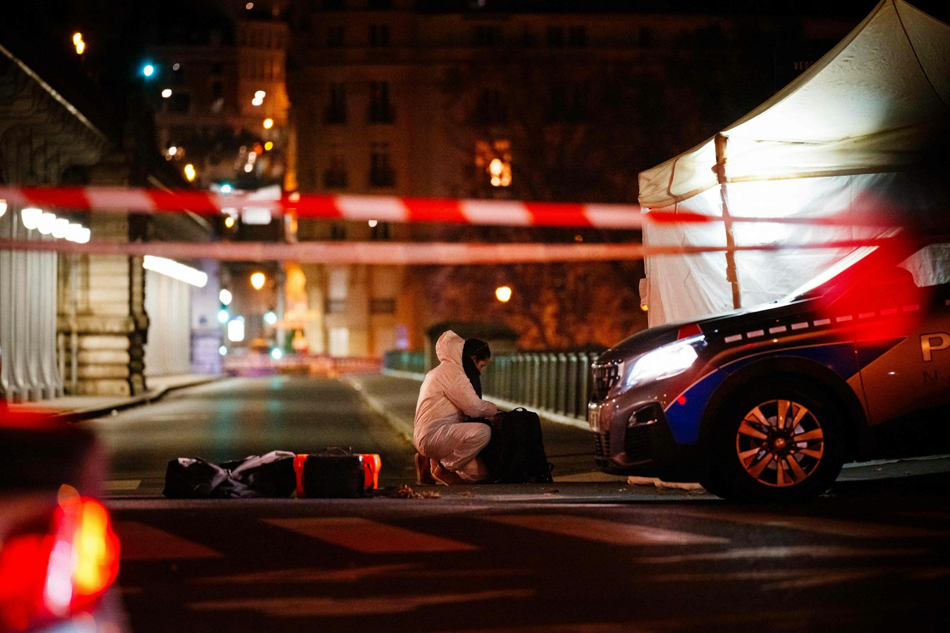 Ein Beamter der Kriminalpolizei arbeitet am Tatort. Ein mutmaßlicher Islamist hat unweit des Eiffelturms am Samstagabend einen deutschen Touristen mit einem Messer getötet.