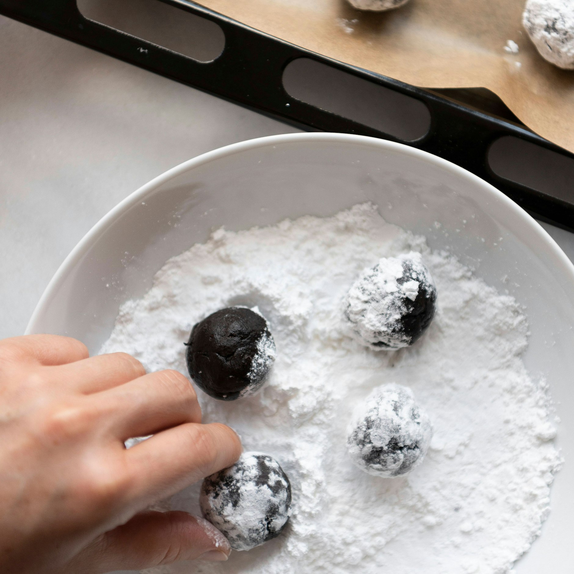Laut Rezept werden die Crinkle Cookies vor dem Backen großzügig in Puderzucker gewälzt.