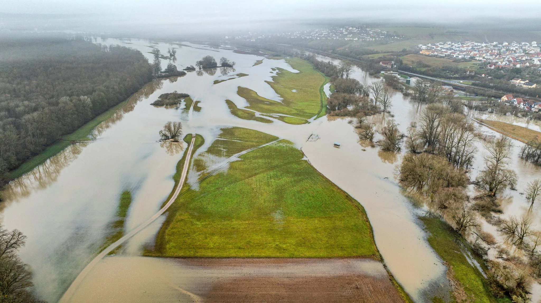 dpatopbilder - Der über die Ufer getretene Main überflutet Wiesen und Felder bei Haßfurt.  