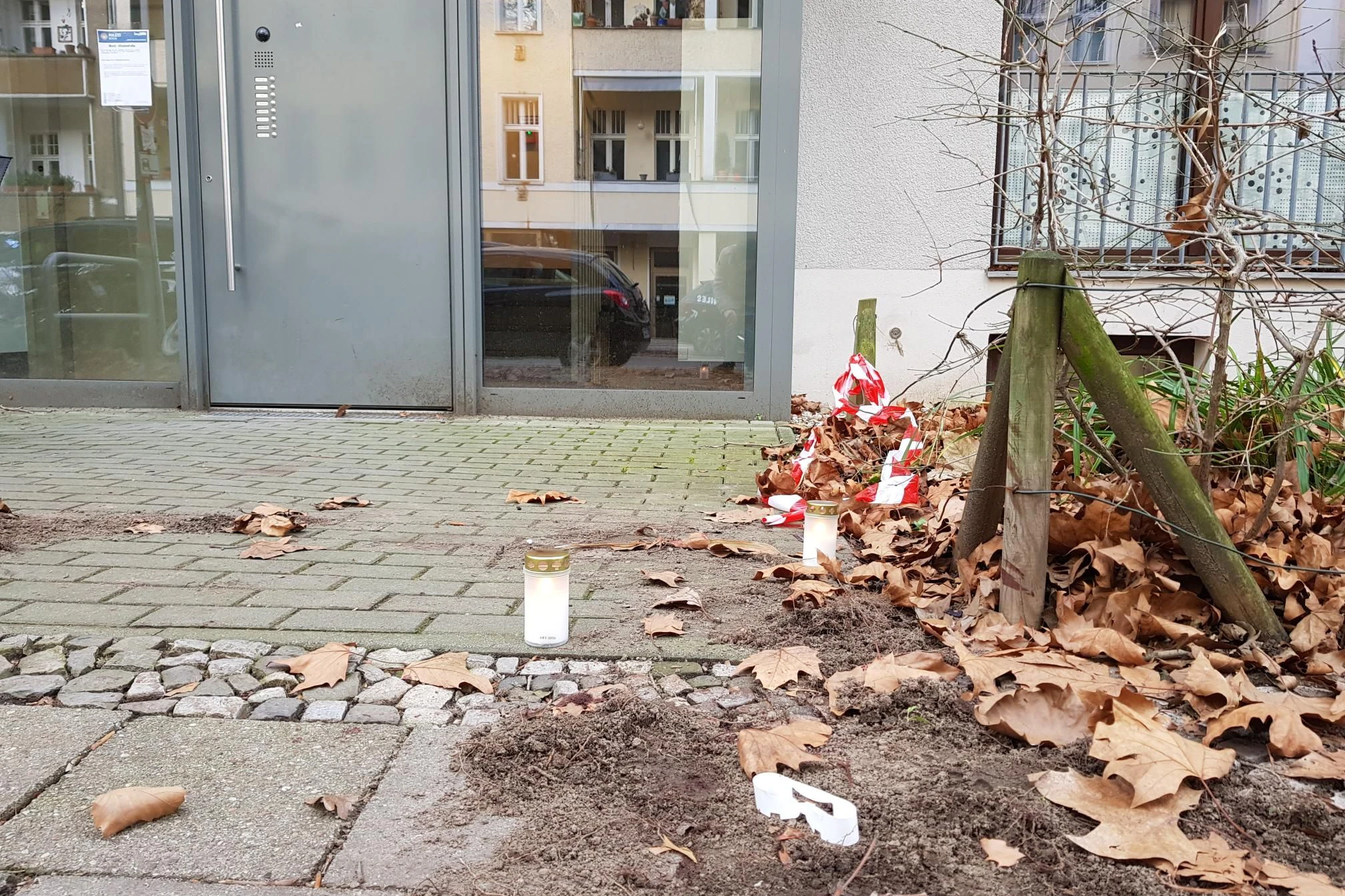 Grabkerzen und ein Flatterband vor dem Wohnhaus in der Vinetastraße erinnern an die Bluttat.