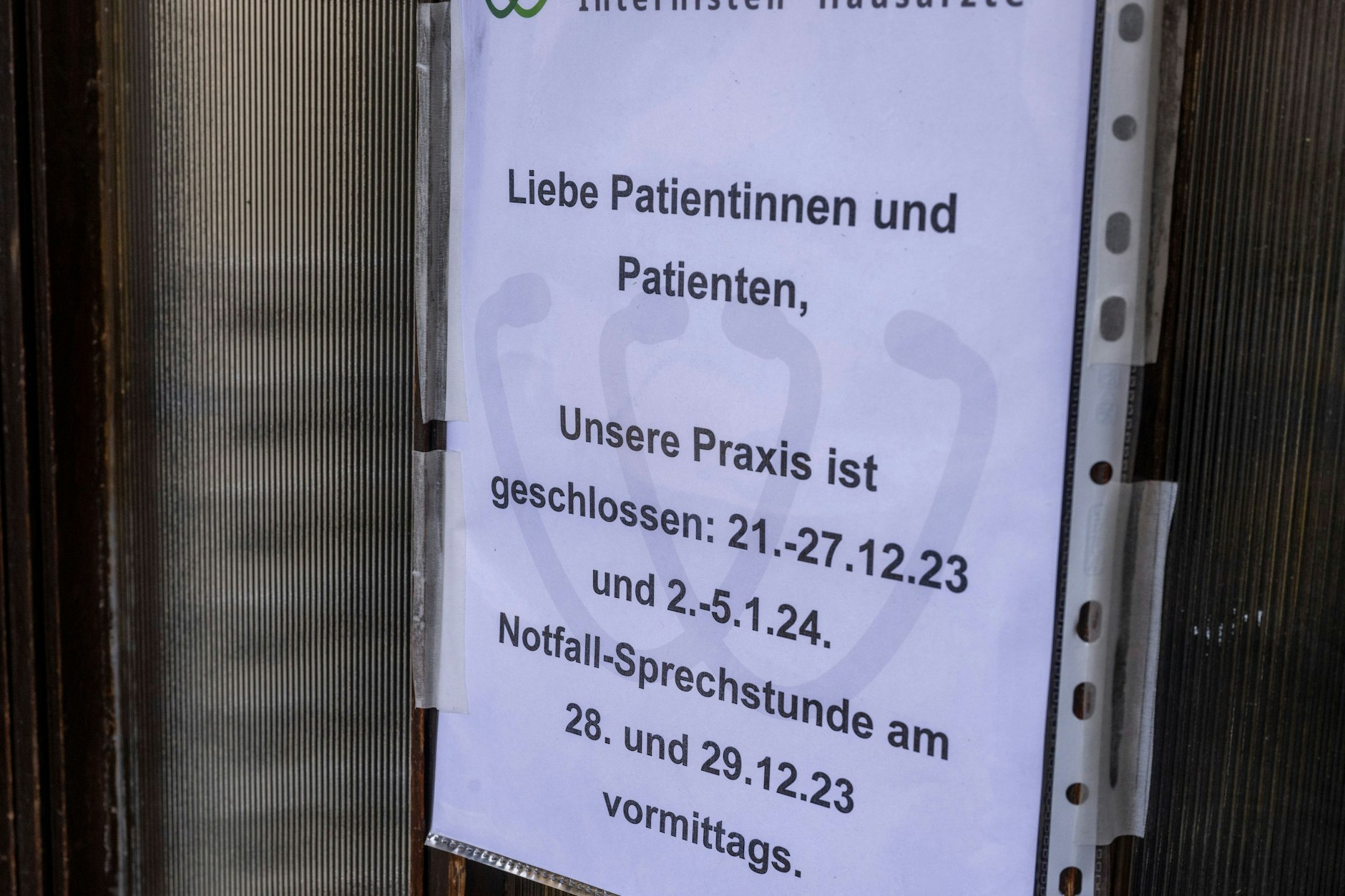 Ein Aushang an der Tür zu einer Arztpraxis in München weist darauf hin, dass die Praxis im Stadtteil Haidhausen geschlossen ist.
