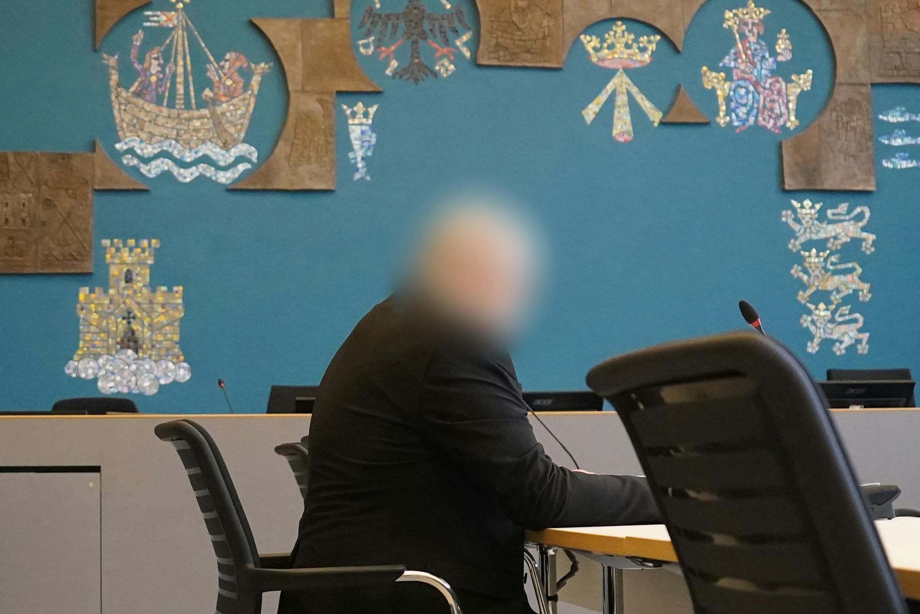 Der Angeklagte sitzt vor Beginn des Prozesses wegen schweren sexuellen Missbrauchs eines Kindes im Sitzungssaal im Landgericht Lübeck. 