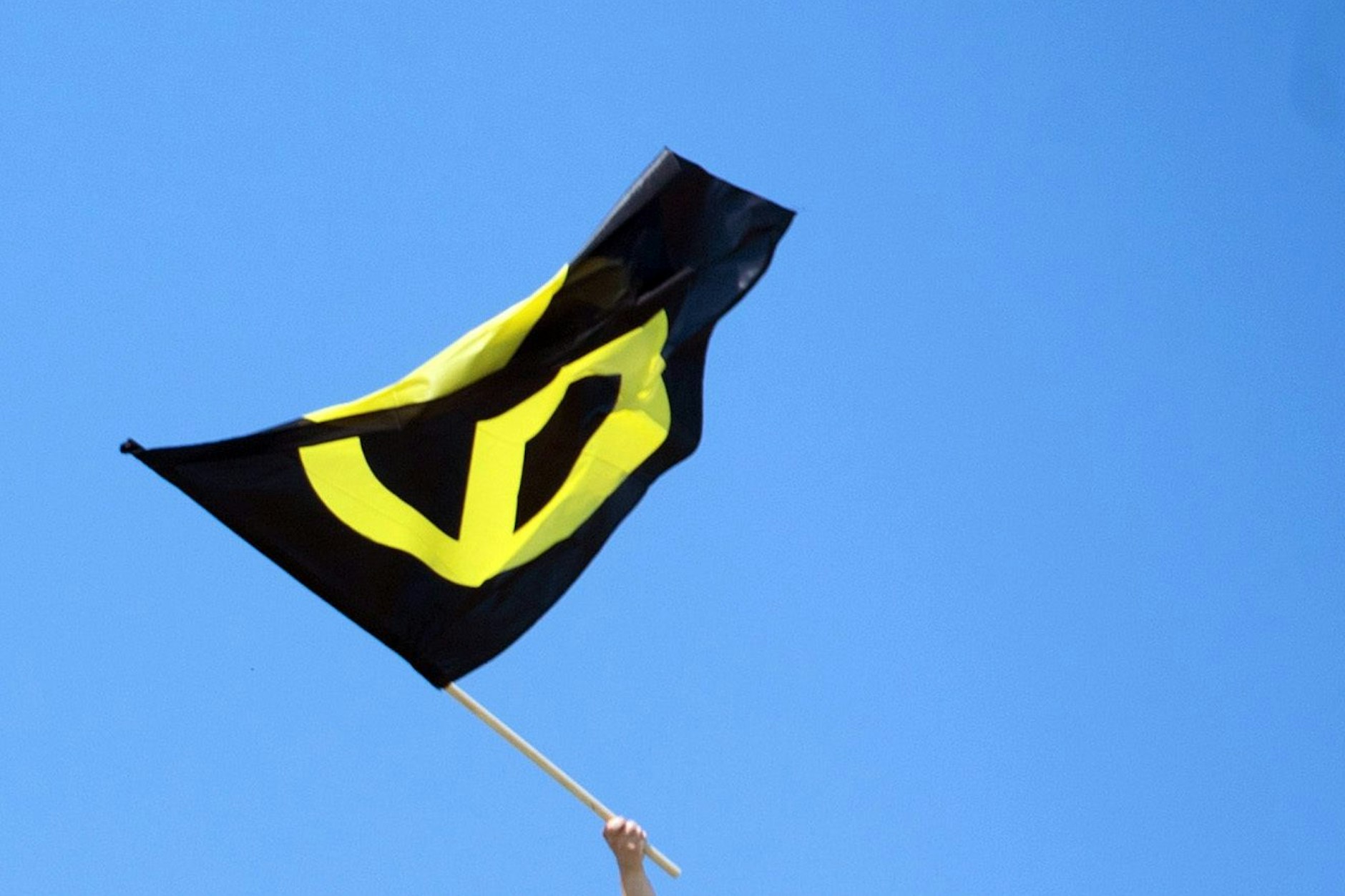 Berlin: Ein Aktivist mit einer Fahne der Identitären Bewegung auf dem Brandenburger Tor.