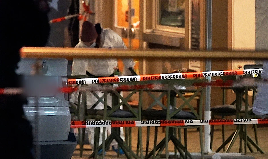 Ein Mitarbeiter der Spurensicherung untersucht den Tatort in der Fußgängerzone in der Bielefelder Innenstadt. Profi-Boxer Besar Nimani ist am Samstagabend durch Schüsse getötet worden.