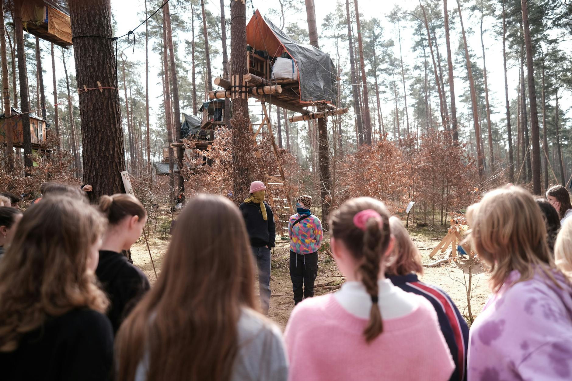 Eine Schulklasse hat am Freitag das Protest-Camp der Initiative „Tesla stoppen“ besucht. Die Protestierenden wollen ihre Baumhäuser nicht abbauen. Das aber fordert eine Auflage der Versammlungsbehörde. 