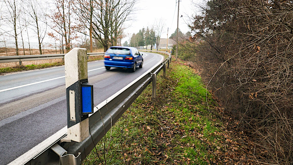 Jeder kennt die schwarz-weißen Straßenpfosten - aber warum haben manche einen blauen Reflektor an der Seite?