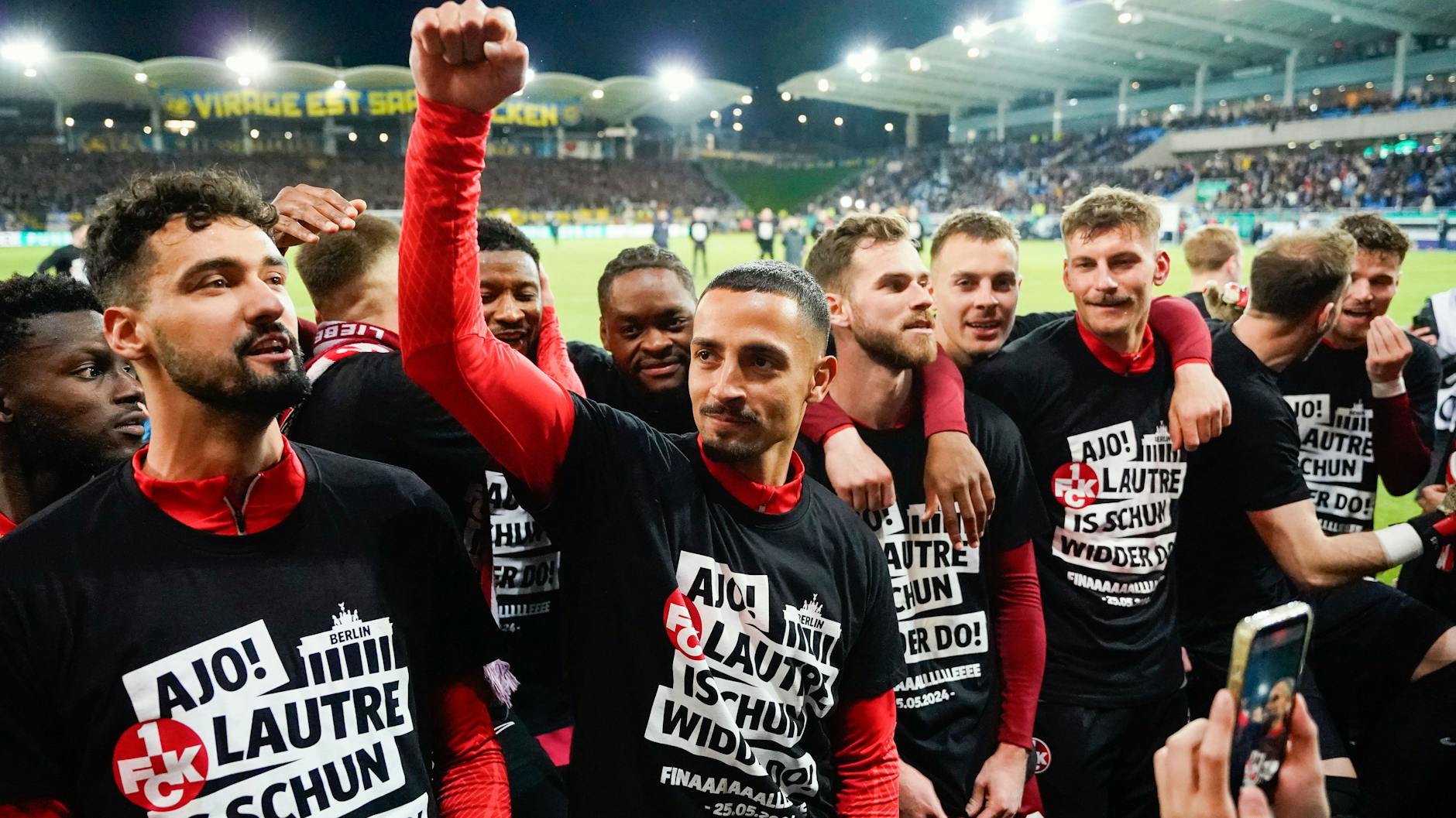 Kaiserslauterns Spieler tragen T-Shirts mit der Aufschrift "Ajo! Lautre is schun widder do!" und feiern ihren Einzug ins Finale des DFB-Pokals.