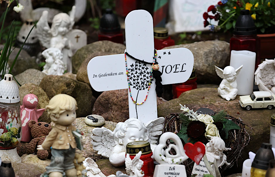An der Stelle, wo der tödlich verletzte sechsjährige Joel im September 2023 gefunden wurde, erinnern Kreuze, Kerzen und Figuren an den Jungen. 