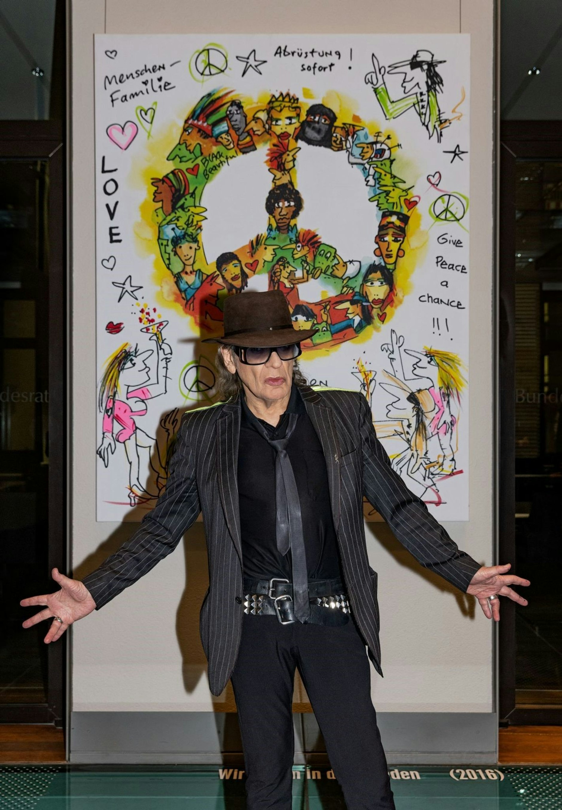 HANDOUT - Der Musiker Udo Lindenberg steht im Bundesrat vor seinem Gemälde «Wir ziehen in den Frieden».  ld