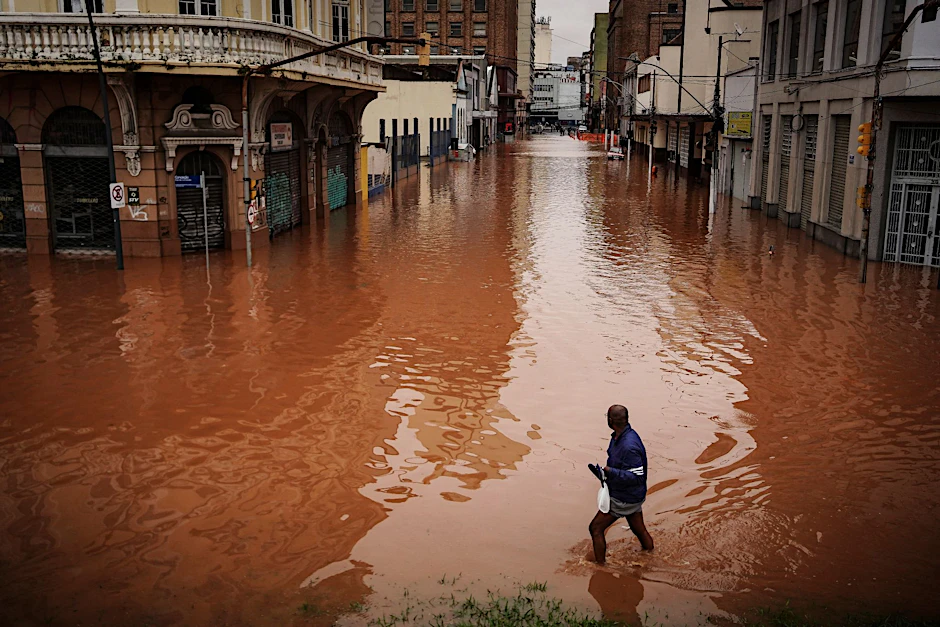 Ein Mann watet in Porto Alegre im brasilianischen Bundesstaat Rio Grande do Sul durch ein von schweren Regenfällen überschwemmtes Gebiet.  