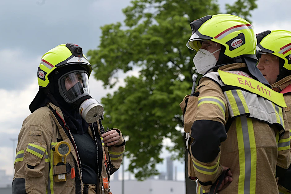 Feuerwehrleute beraten sich.  