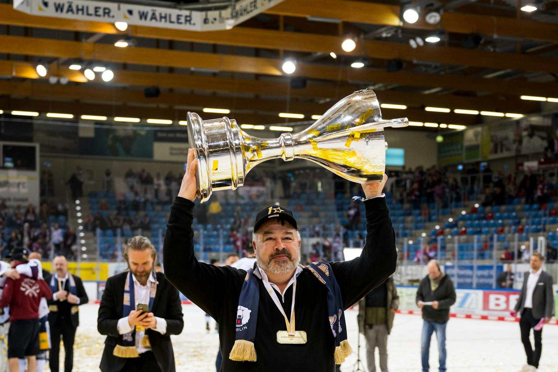 Eisbären-Sportdirektor Stephane Richer stemmt den Meisterpokal.